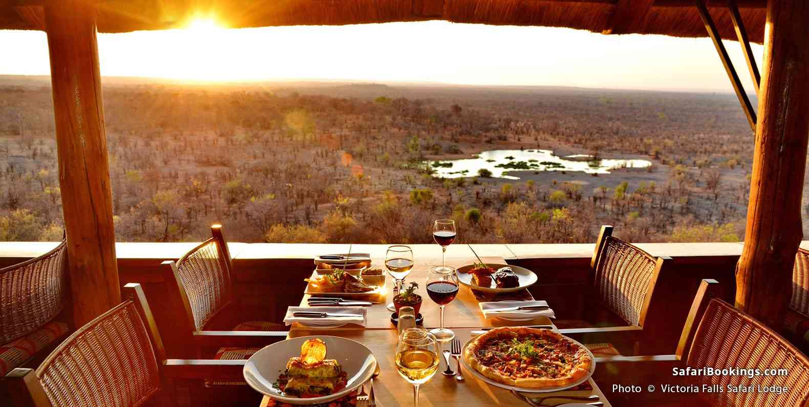 Food served on the terrace of Victoria Falls Safari Lodge with the view of the waterhole