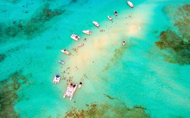 Aerial view of boats and people snorkeling