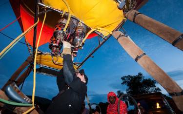 Firing up a hot-air balloon at dawn