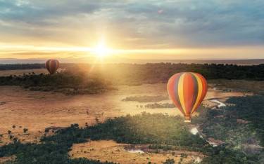 Thumbnail of Hot-air balloons floating over the Masai Mara
