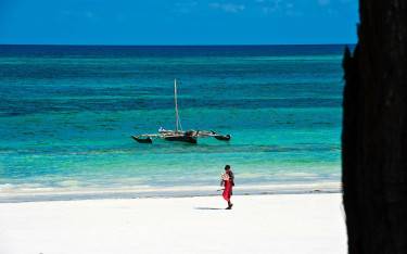 Maasai walking on the beach