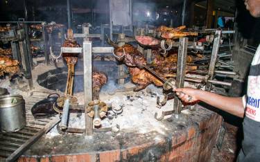 Chef grilling meat at Carnivore Restaurant