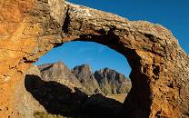 The Three Bushmen (Devil's Knuckles) mountains in Sehlabathebe NP seen through a rock arch
