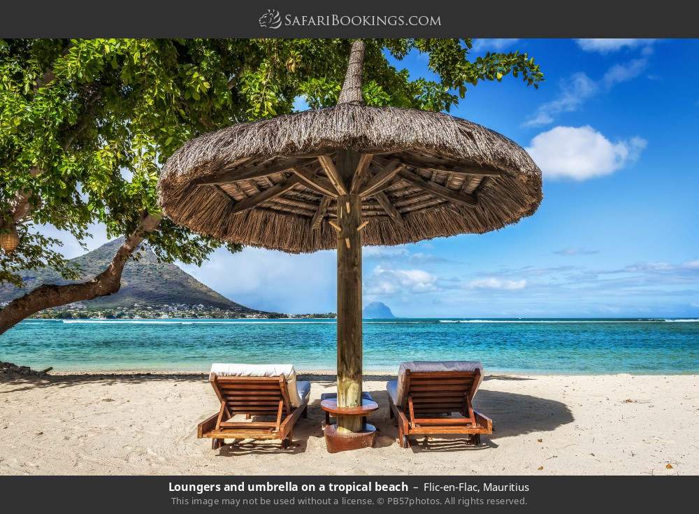 Loungers and umbrella at Flic-en-Flac Beach in Flic-en-Flac, Mauritius