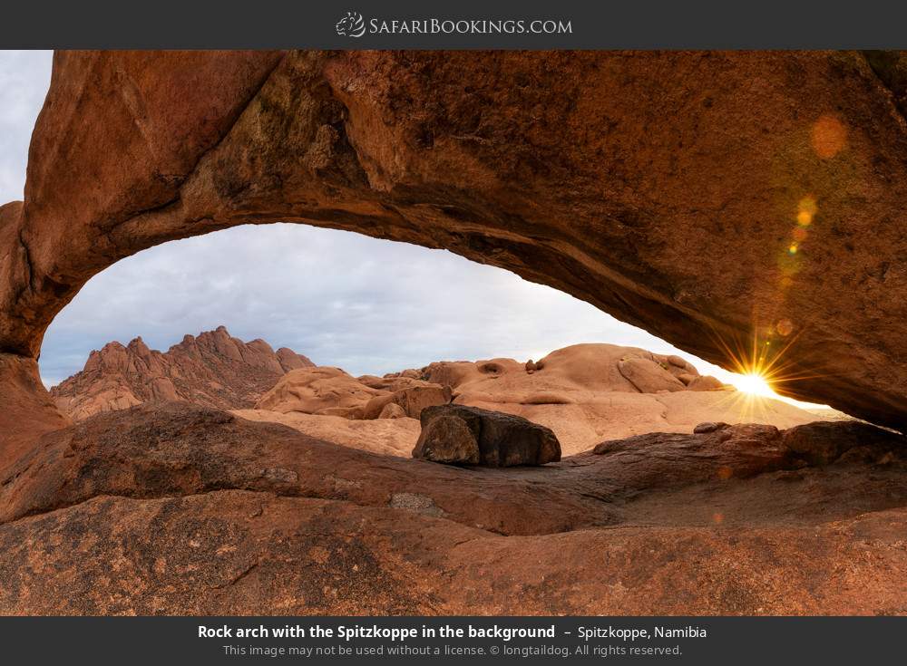 Rock arch with Spitzkoppe mountain in the background in Spitzkoppe, Namibia