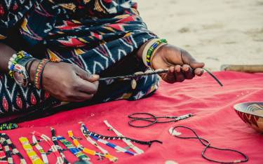 Thumbnail of Maasai vendor selling beadwork on the beach