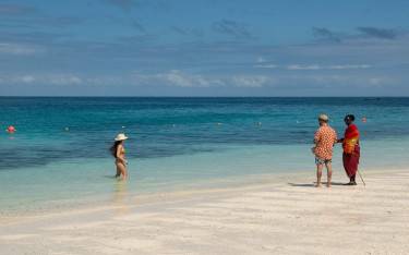 Visitor talking to a Maasai man on the beach
