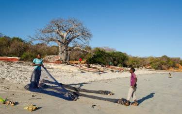 Fishers preparing nets on the beach