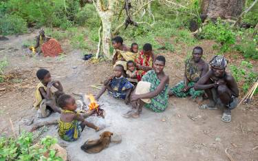Hadzabe family sitting by the fire