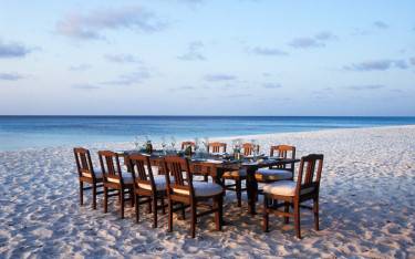 Thumbnail of Dining on the beach at Mnemba Island Lodge on Mnemba Island