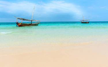 Thumbnail of Small dhows on the azure blue waters surrounding the island