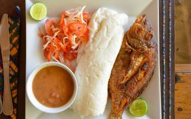 Traditional Swahili food with ugali and grilled fish