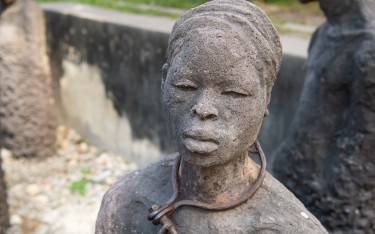 Sculpture of a slave chained in a pit at the Old Slave Market