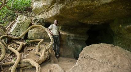 Guide standing at the entrance to the cave