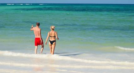 People walking into the sea