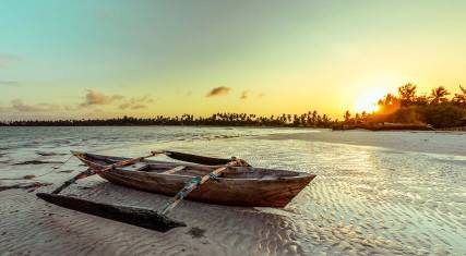 Boat lying on the tidal flats at sunset